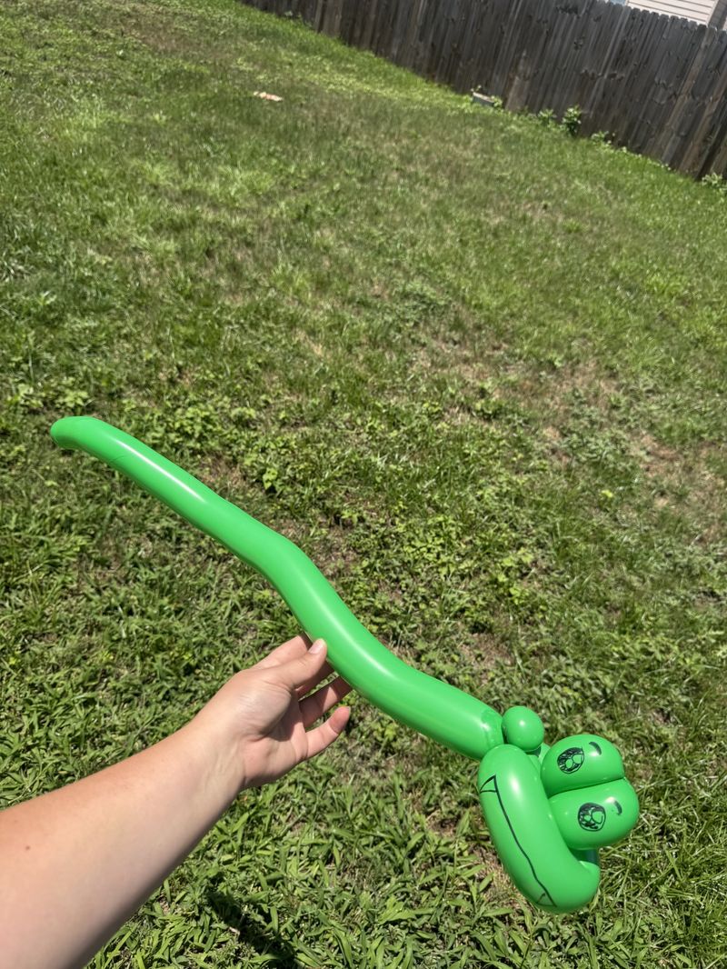 Green balloon snake at a kids party in Texas