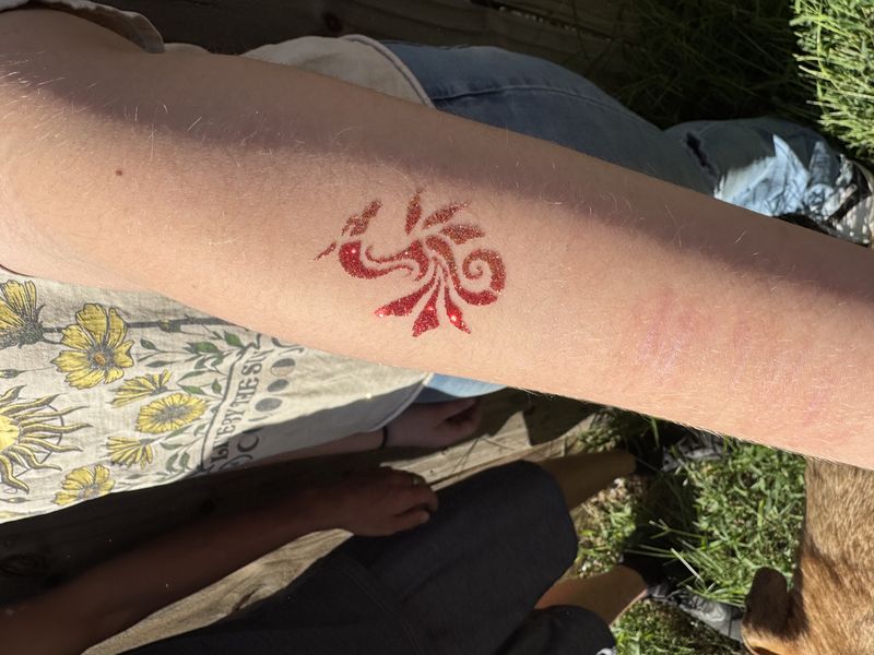 Red dragon glitter tattoo design for party entertainment in Texas