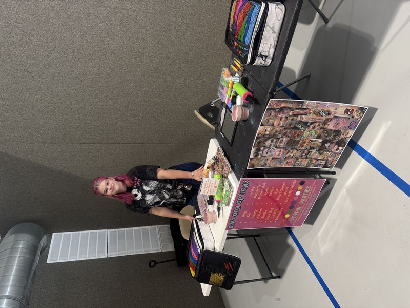 Poppin Parties face painting artist setup at an indoor Texas event