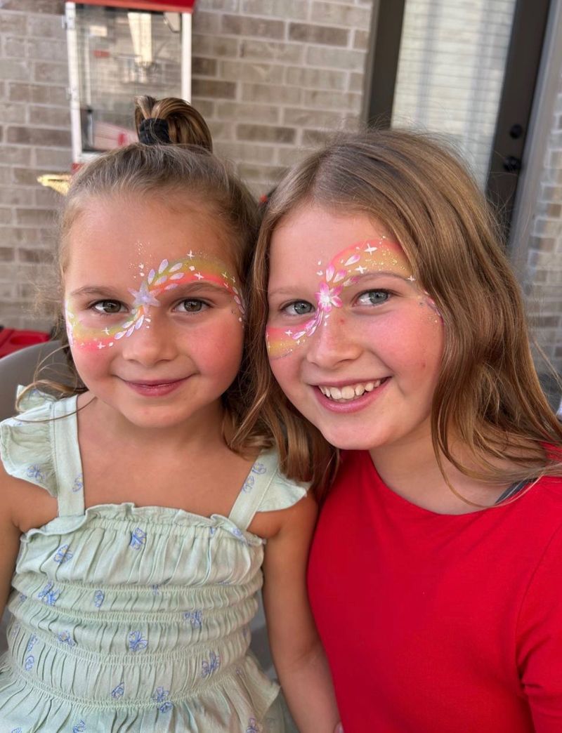 Rainbow floral face painting at a girls birthday party in Texas